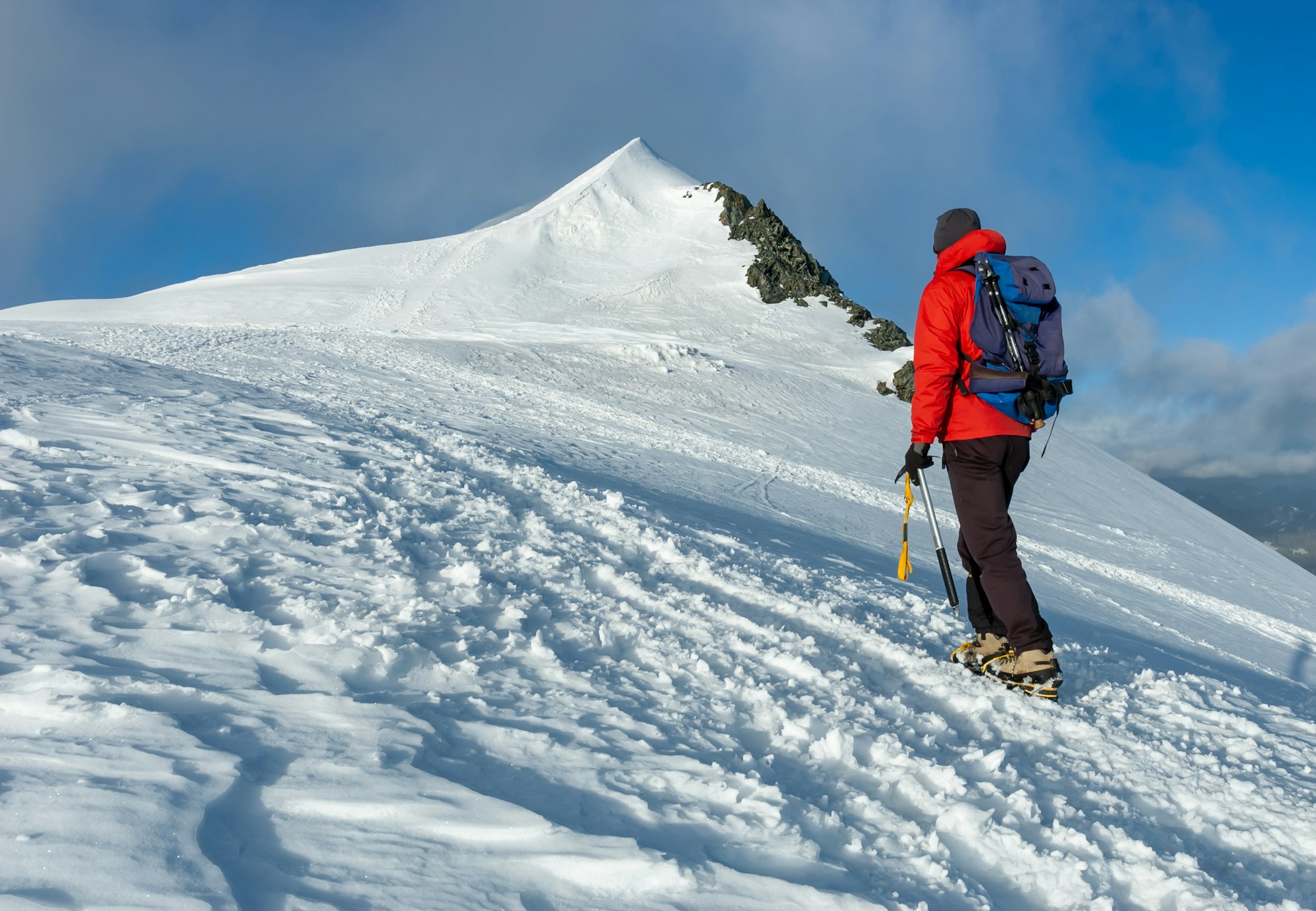mountaineer climbs a snowy peak in swiss alps zermatt switzerland .jpg